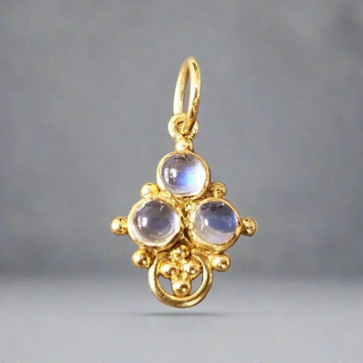 Elegant gold pendant with three moonstones, vintage-inspired design for luxury jewelry lovers