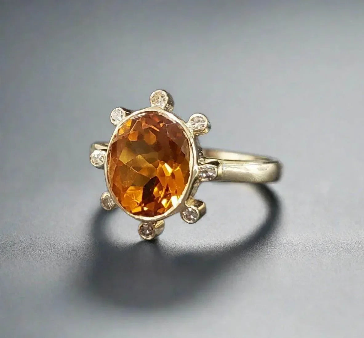 Elegant gold ring with oval citrine gemstone and diamond accents, perfect for luxury jewelry lovers