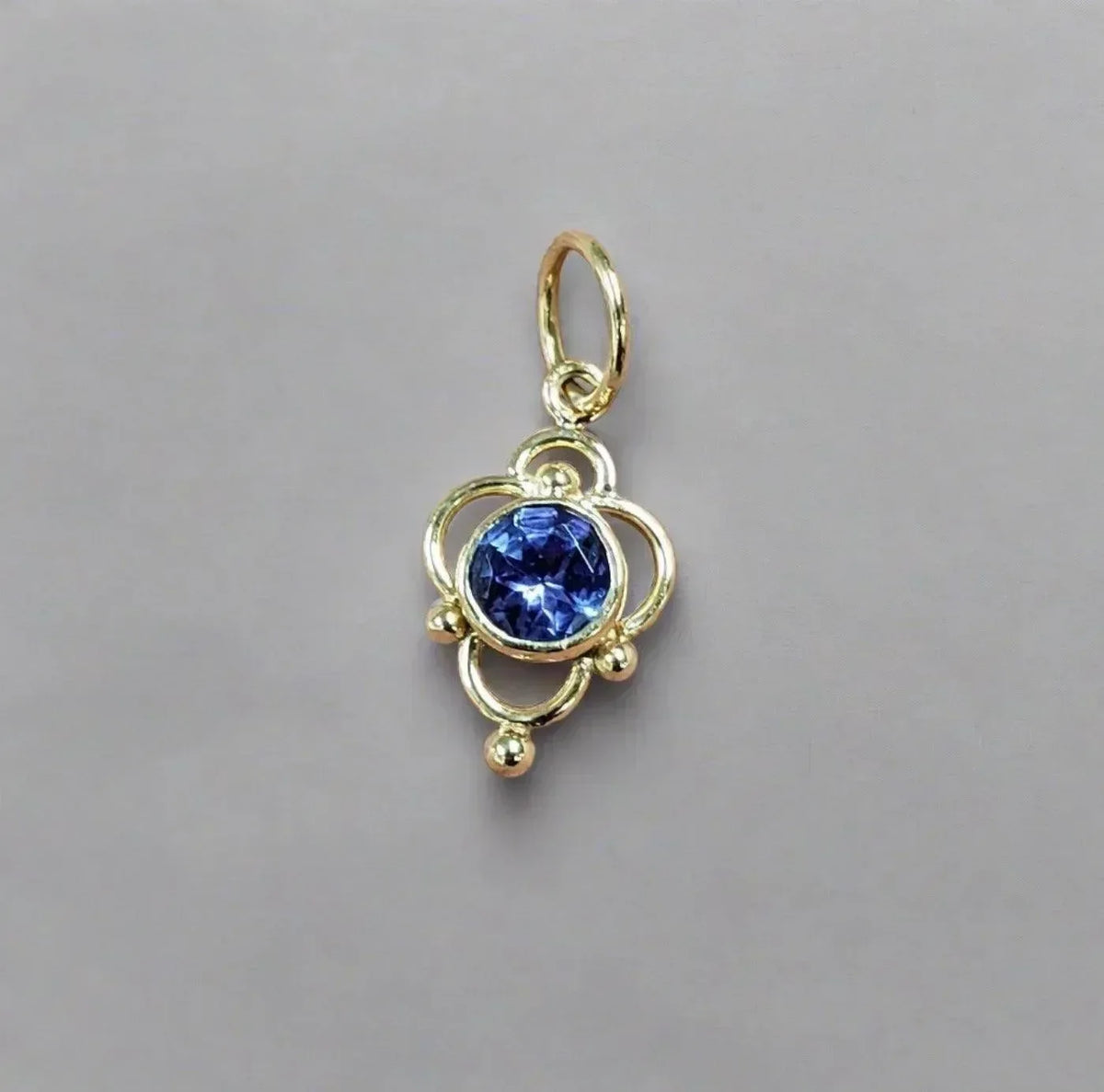 Gold pendant with blue gemstone, elegant jewelry accessory for necklaces