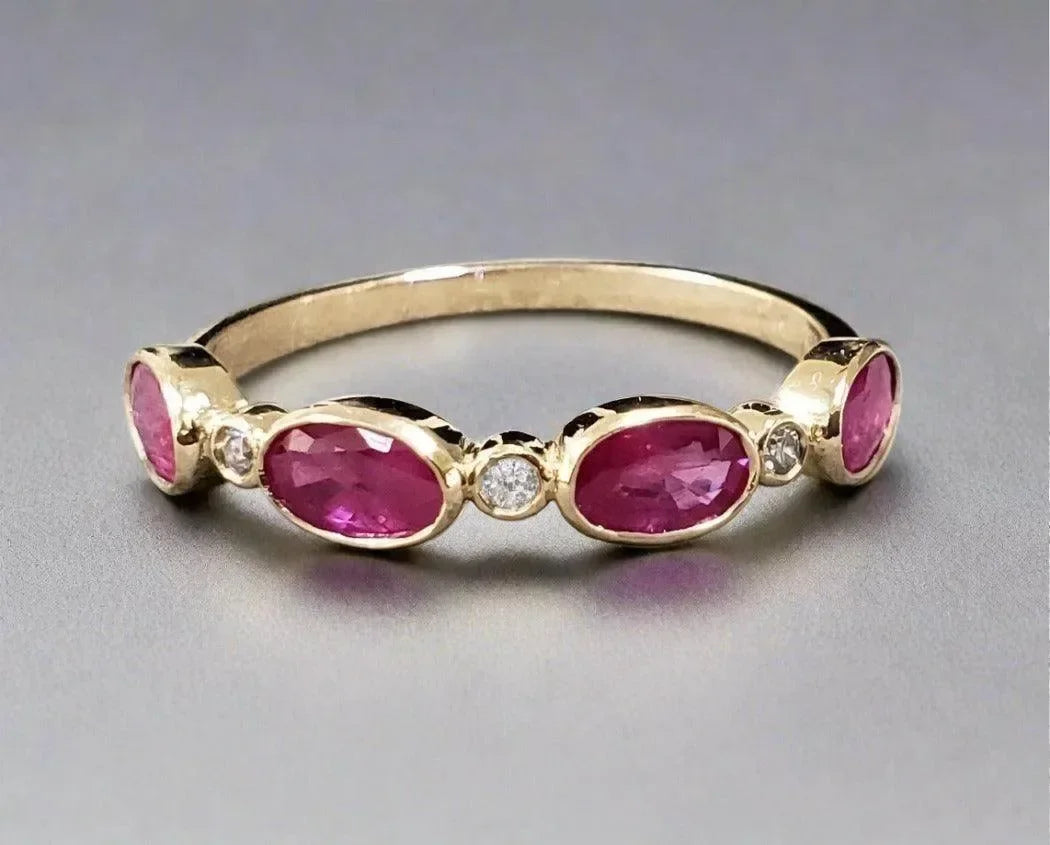 Elegant gold ring with oval pink gemstones and diamond accents, perfect for luxury jewelry lovers
