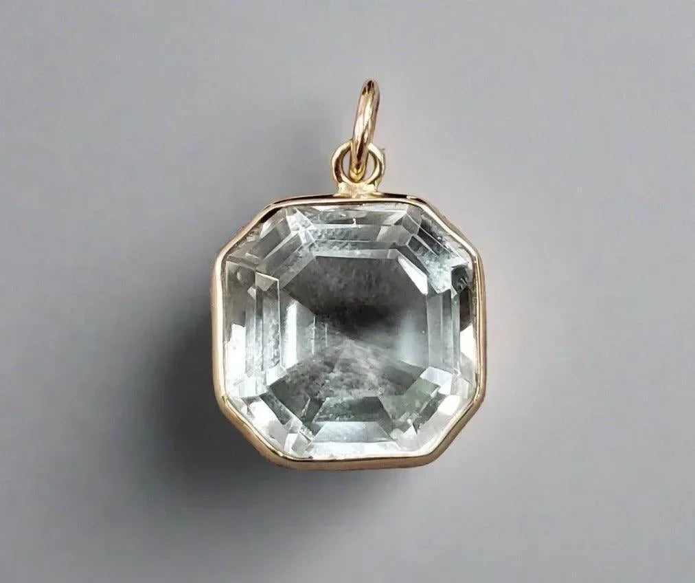 Faceted octagon gemstone pendant in gold setting, elegant jewelry accessory
