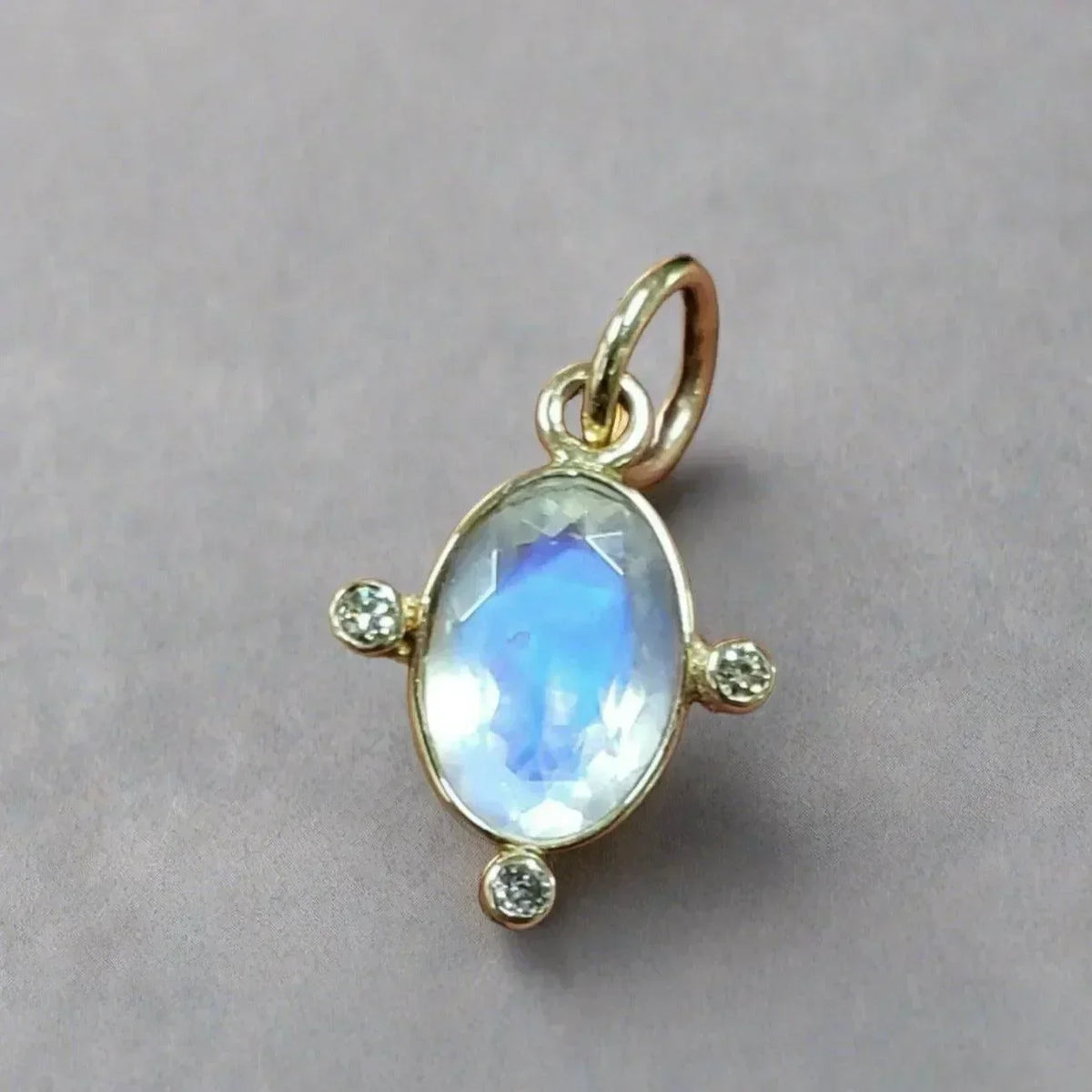 Elegant gold pendant with oval moonstone and diamond accents, perfect for sophisticated jewelry lovers